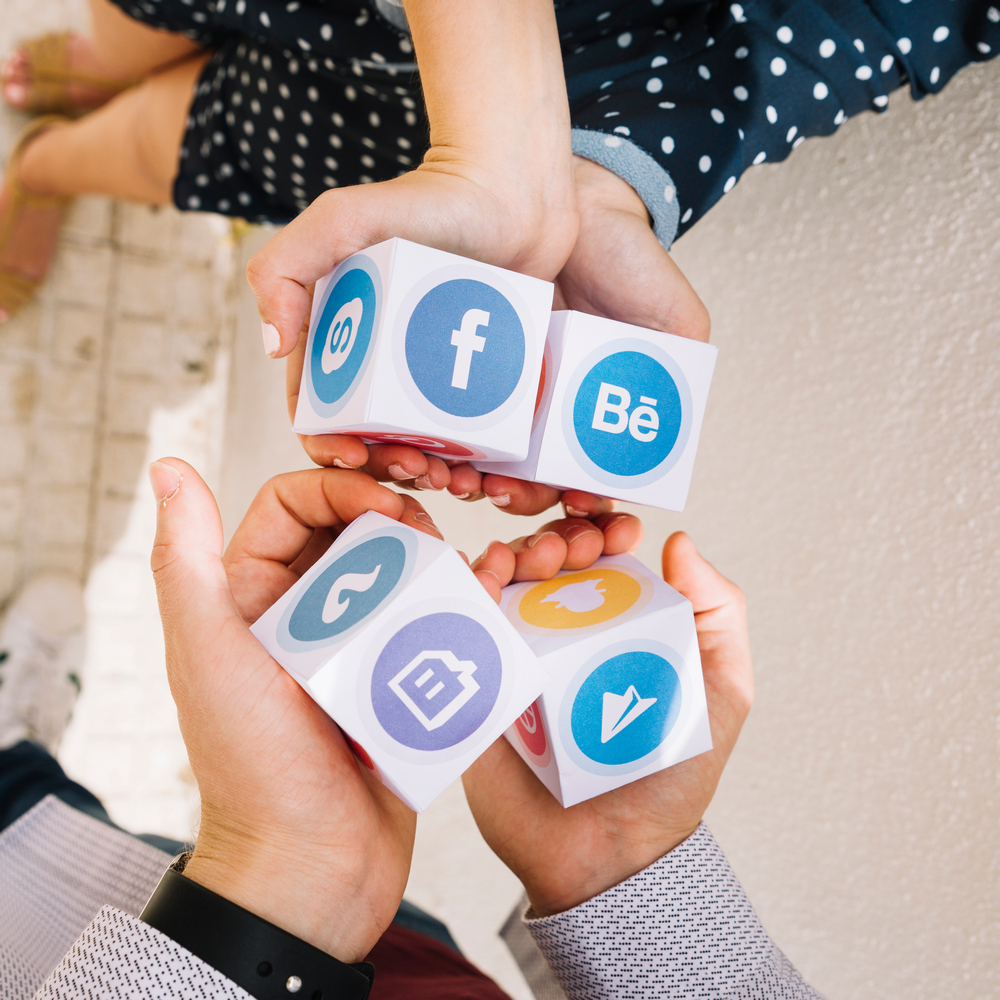 elevated-view-human-hands-holding-blocks-mobile-application-icons.jpg
