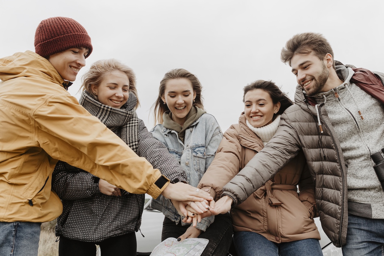 happy-friends-putting-hands-together.jpg